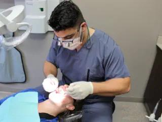 Dr. Philip Lubus examining a patient at Lubus Family Dentistry in Sarnia